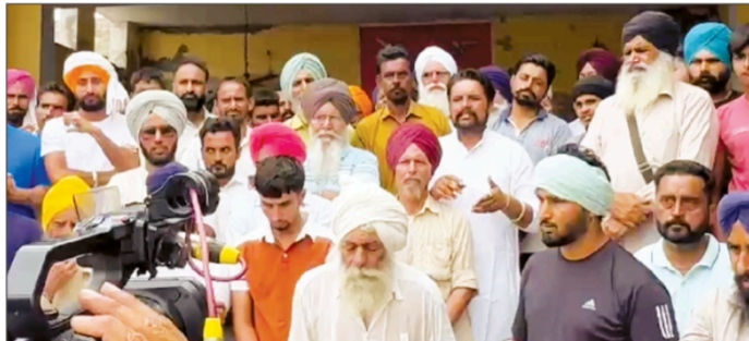 The entire village stood in support of the youth who put up the poster of 'Village for sale' when it was threatened by the police.
